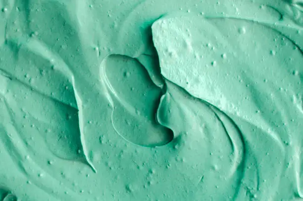 Photo of Green cosmetic clay texture close up. Abstract background.