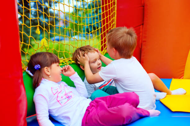 istock excited kids having fun on inflatable attraction playground 665013686