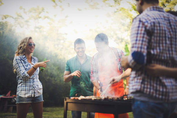 istock Happy people having camping and having bbq party outdoor 665016646