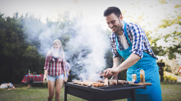 istock Handsome man preparing barbecue for friends outdoor 665016764