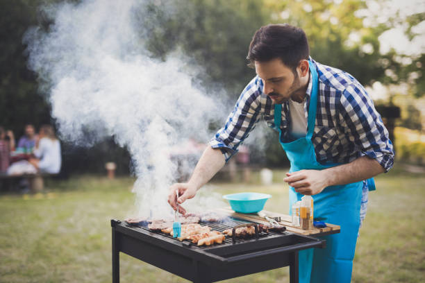 istock Handsome man preparing barbecue for friends outdoor 665016876