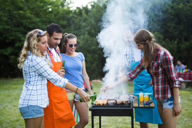 istock Friends having fun grilling meat enjoying bbq party 665016890