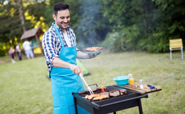 istock Handsome man preparing barbecue for friends outdoor 665017008