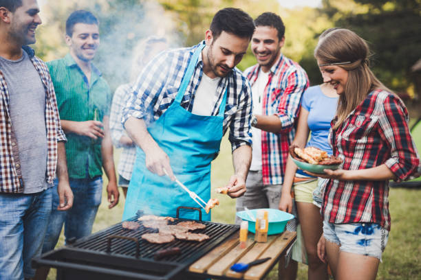 istock Friends having a barbecue party in nature  while having a blast 665017084
