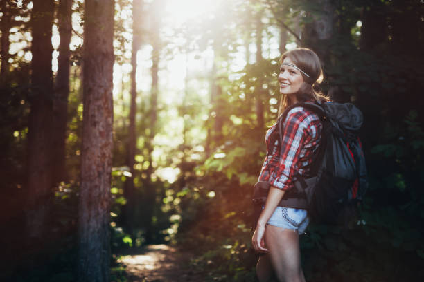 istock Female backpacker set out on forest hike advanture 665017096