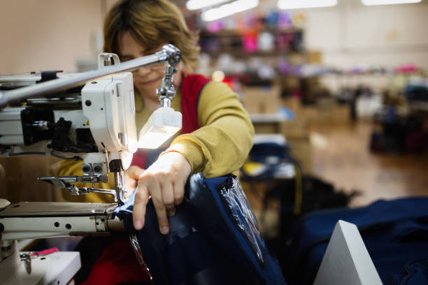istock Woman working in sewing industry on machine 665019726
