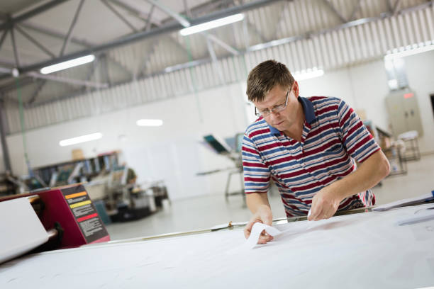 istock Professional industrial clothing designer working according to scheme 665020840