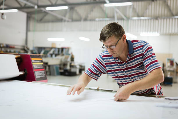 istock Professional industrial clothing designer working according to scheme 665020854