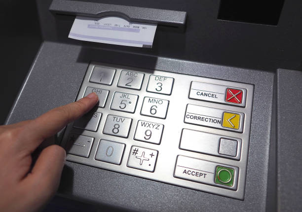 istock ATM button close-up and paper transaction. 665021128