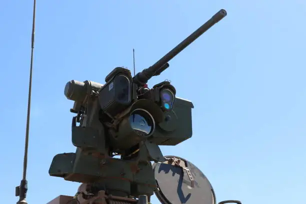 Remote controlled gun mounted on top of military vehicle