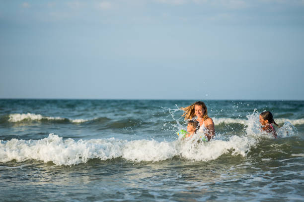 istock Child splashig in sea waves 665023658