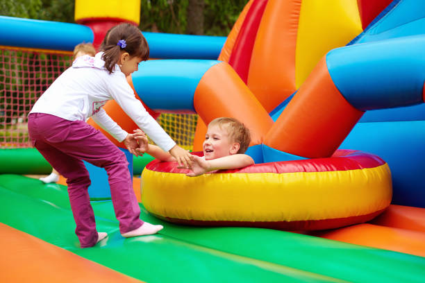 istock happy kids having fun on inflatable attraction playground 665023992