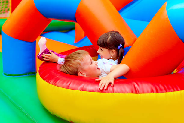 excited kids having fun on inflatable attraction playground