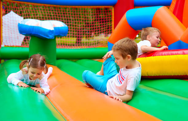 istock happy kids having fun on inflatable attraction playground 665024124
