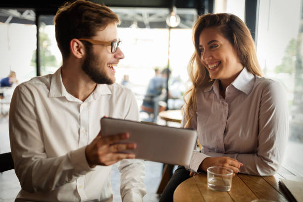 istock Business people talking and laughing together at cafe 665025214