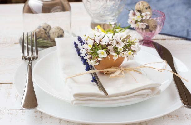 istock Romantic wedding table setting, lavender, white plates, napkin, flowers, Easter decoration, outdoors 665028188