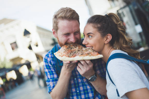 istock Positive happy students eating pizza on street 665031014