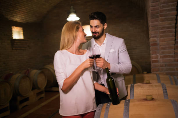 istock People tasting red wine in winery basement 665032012
