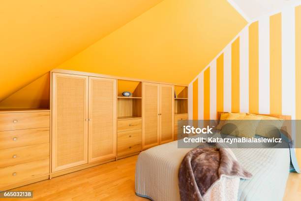 Attic Bedroom With Intense Yellow Walls Stock Photo - Download Image Now - Bedroom, Yellow, Multi Colored