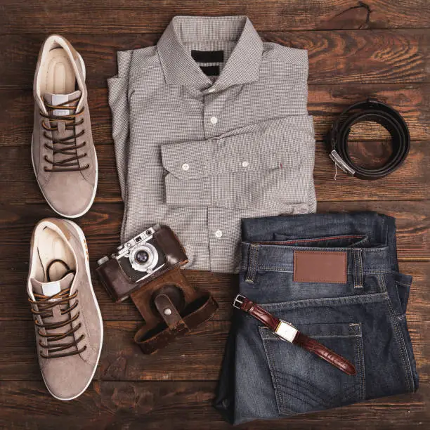 Photo of Flat lay of modern men's clothing on a wooden background