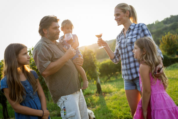 istock Winemaker family happy together in vineyard before harvesting 665034920