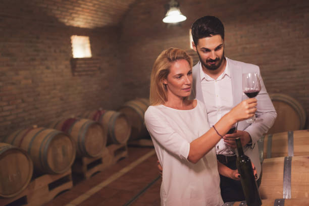 istock Wine loving couple tasting wines in winery cellar 665035464