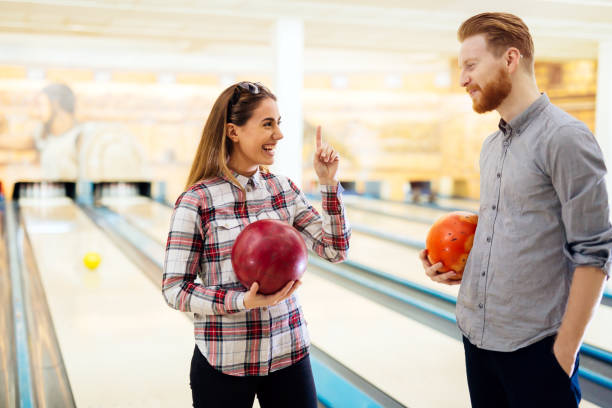 istock Dating couple enjoy bowling together 665037976