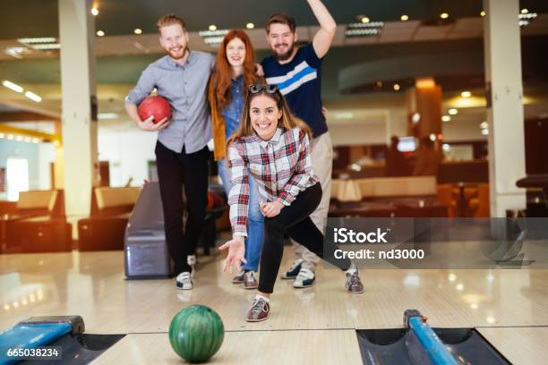 Friends Enjoying Recreational Bowling At Club Stock Photo - Download Image Now - Activity, Adult, Arts Culture and Entertainment