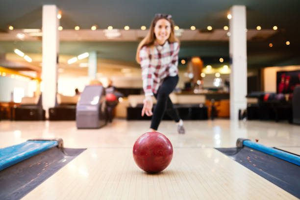 istock Beautiful woman enjoying  bowling 665038418