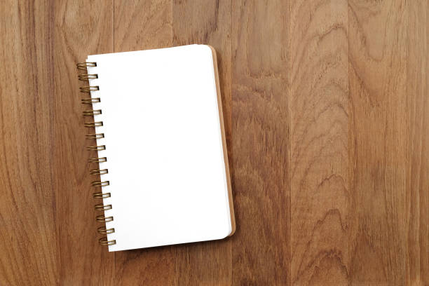 istock Blank note book on wood background, with copy space for text, flat lay 665045848