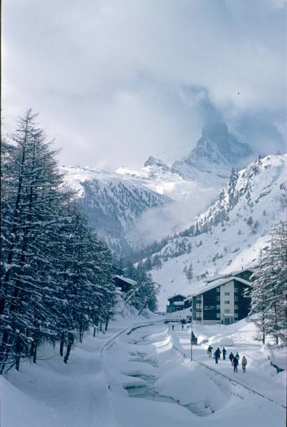 Zermatt, Valais, Switzerland, 1976. Zermatt in the winter. In the background the cloud-covered Matterhorn.