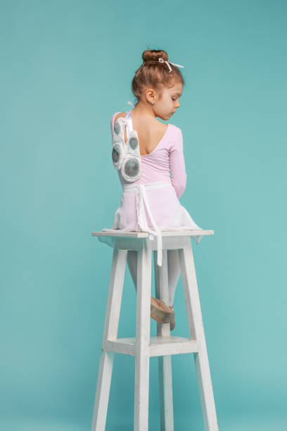 istock The little balerina dancer on blue background 665054784