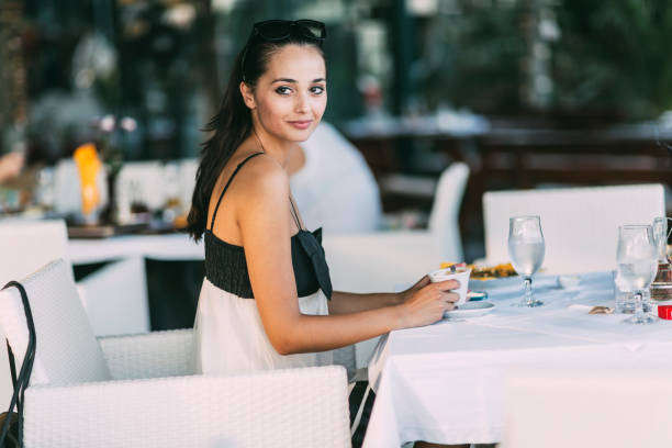 istock Beautiful woman drinking tea in restaurant while waiting for her meal 665055372