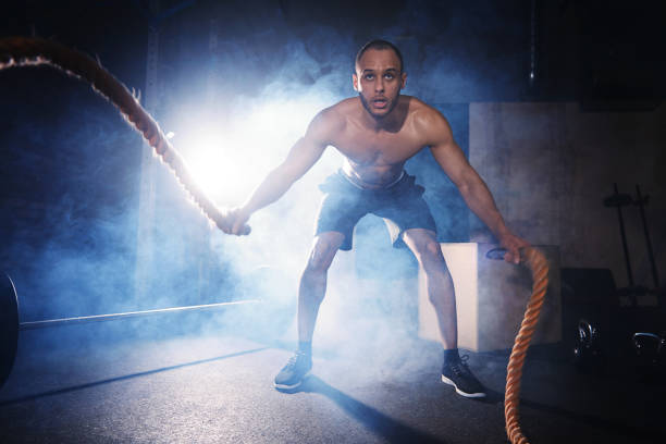 istock Full length of man exercising with ropes 665059992