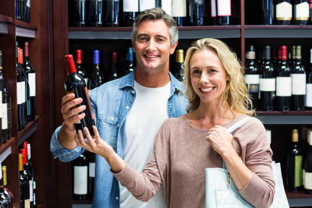 istock Smiling couple with bottle of wine 665060214