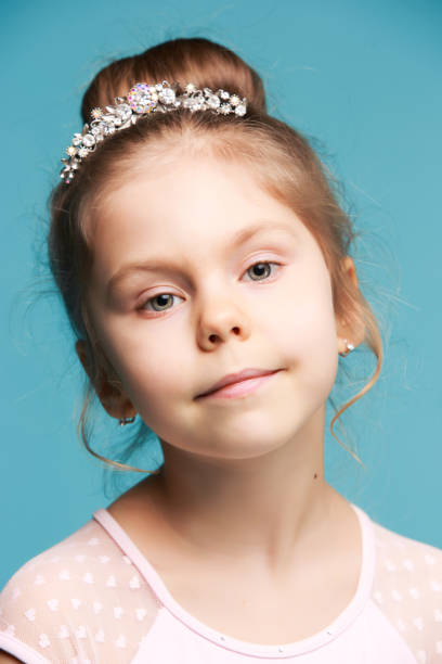 istock Cute little girl on a blue background close-up 665063732