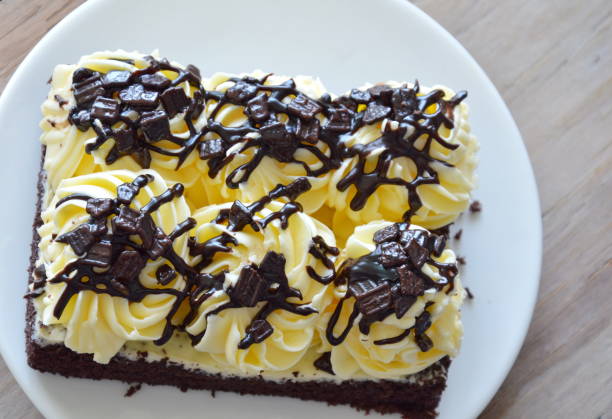 istock chocolate cake topping cream on dish 665064926