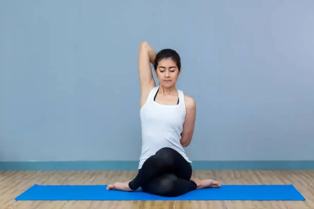 Asian young woman practicing yoga in the room and sport yoga,yoga in the room,sport yoga,yoga practice,yoga relax