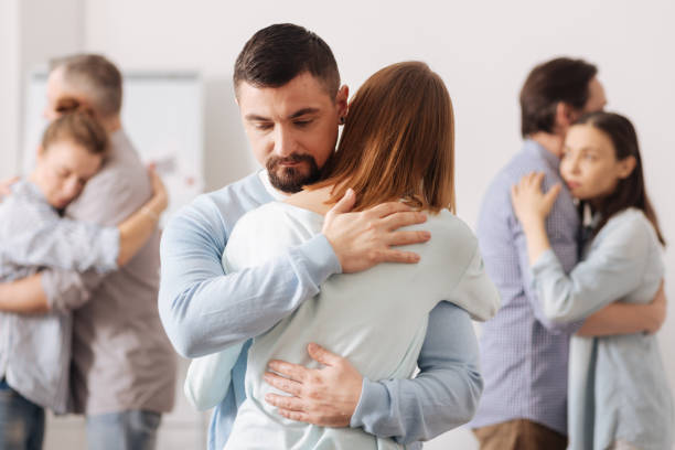istock Serious man hugging his female colleague 665075916