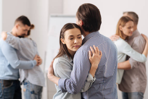 istock Serious brunette hugging her colleague 665076184