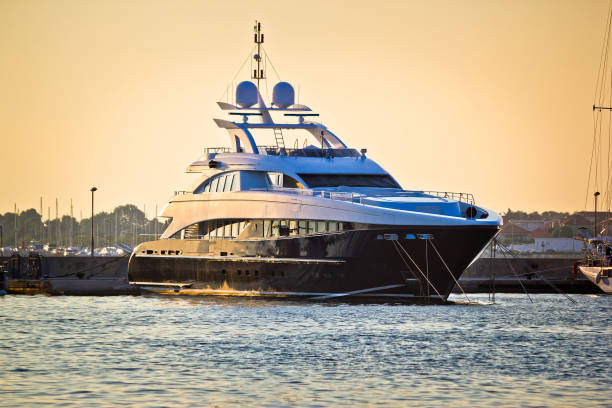 istock Luxury yacht in harbor on golen sunset 665081310