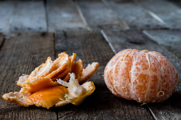 istock Mandarin on old wooden table in old kitchen 665087816