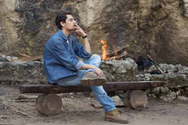 Photo of Smoking next to the fire