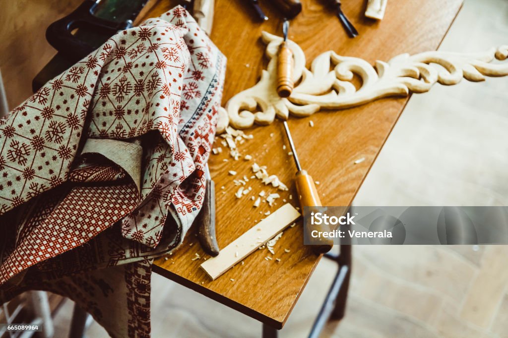 a craftsman carves wood the hands of the craftsmen carved wooden product Activity Stock Photo