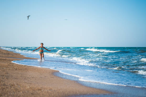 istock Child running at sea waves 665095044