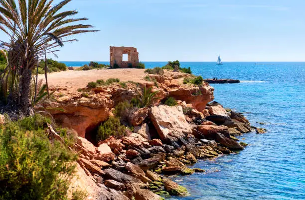 Rocky coastline of Punta Prima. Province of Alicante. Southern Spain