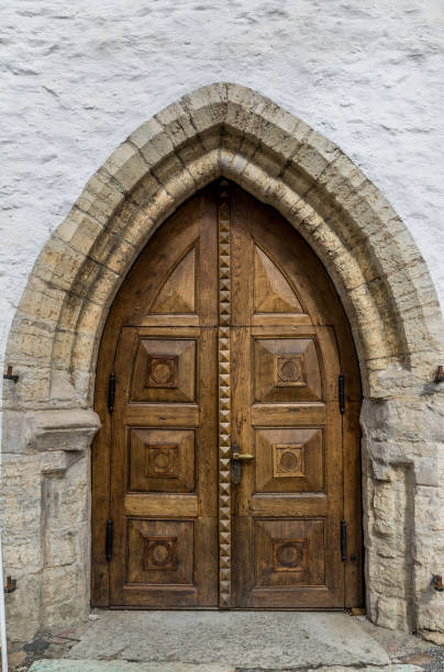 An antique wooden door handle on an old entrance door, showcasing intricate craftsmanship, aged textures, and timeless elegance. This vintage detail highlights the beauty of traditional architecture and historical design.