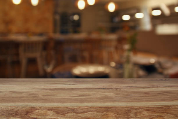 istock wooden table in front of abstract restaurant lights background 665114062