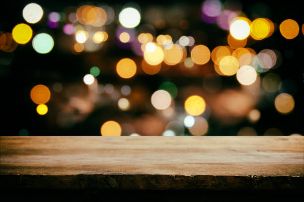 istock wooden table in front of abstract restaurant lights background 665117644