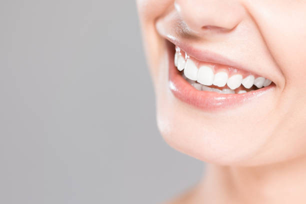 istock Beautiful smile young woman. White teeth on the master plan. 665117720